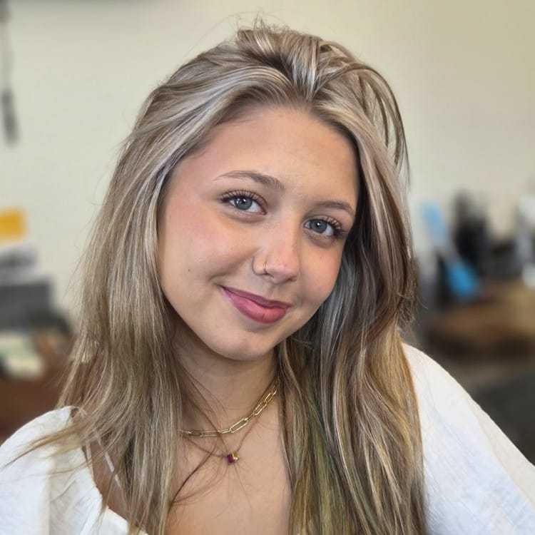 Portrait of Bri, a professional stylist at ARIA Salon, showcasing their expertise and style.