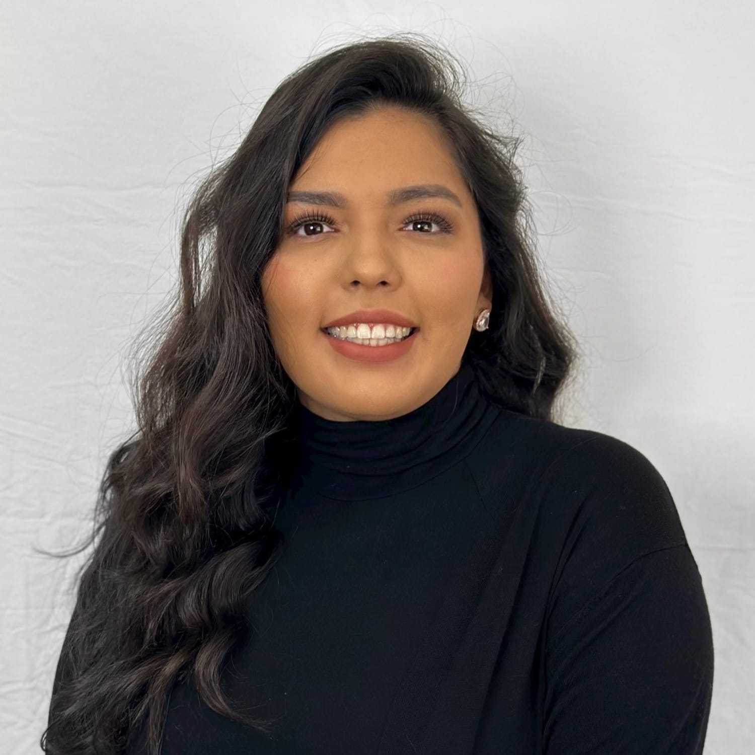 Portrait of Amairany, a professional stylist at ARIA Salon, showcasing their expertise and style.