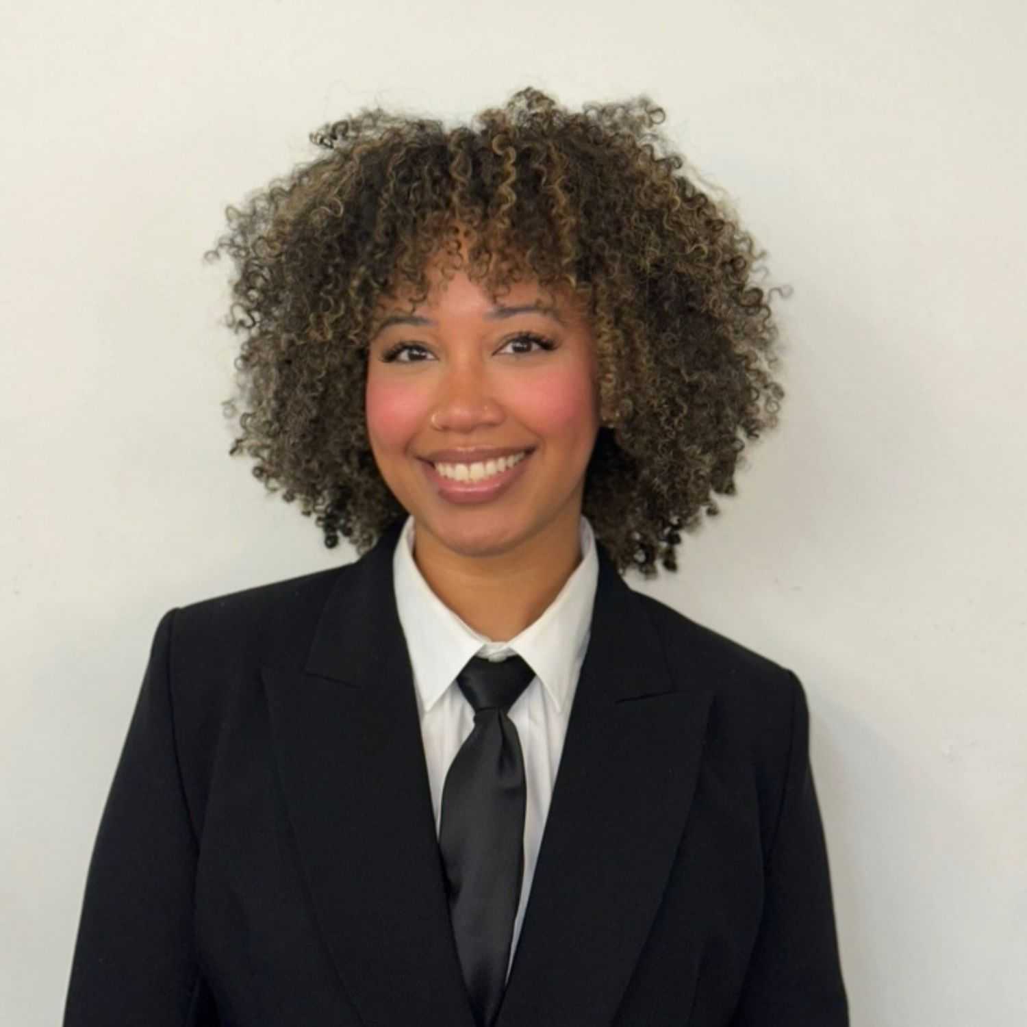 Portrait of Sammie, a professional stylist at ARIA Salon, showcasing their expertise and style.