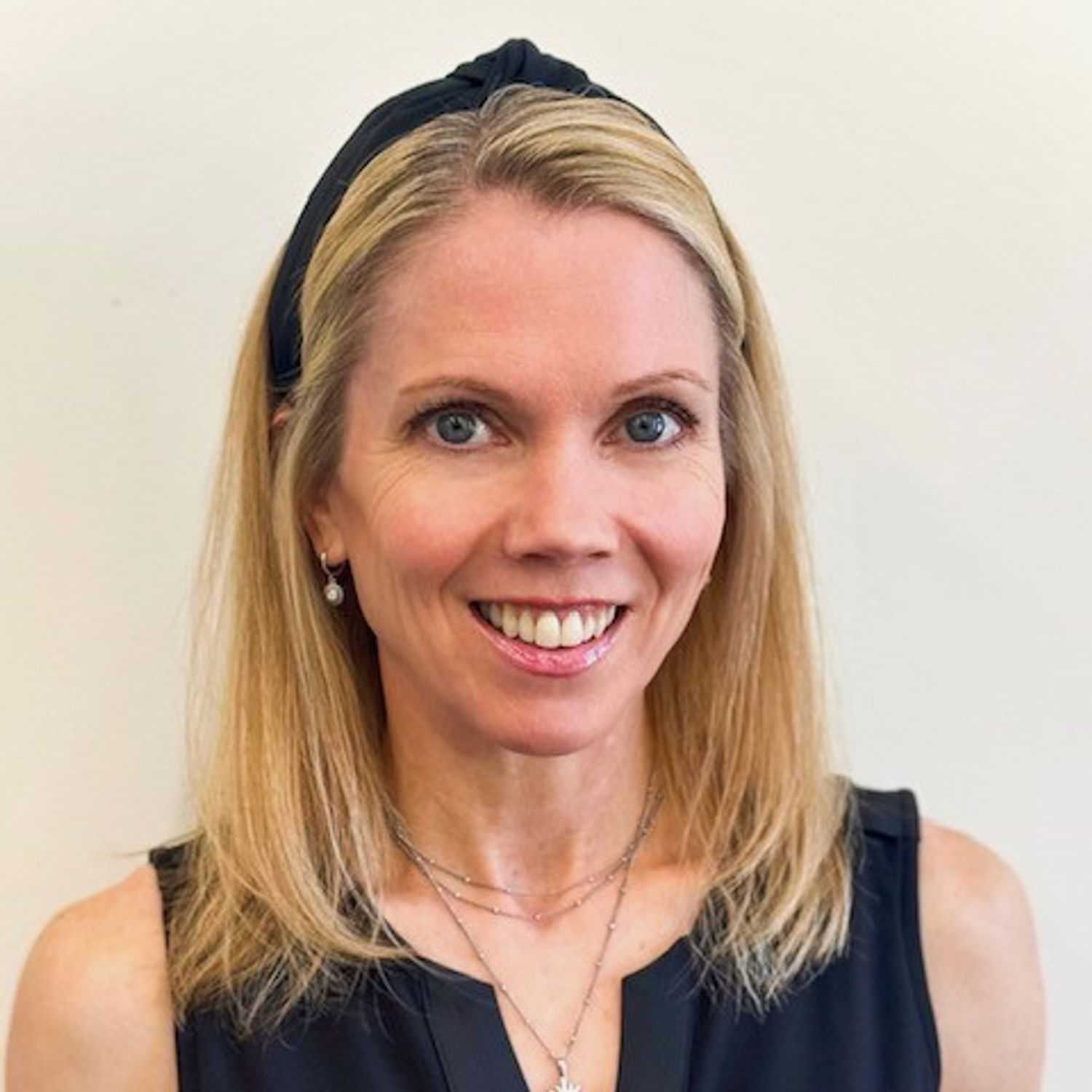 Portrait of Courtney, a professional stylist at ARIA Salon, showcasing their expertise and style.