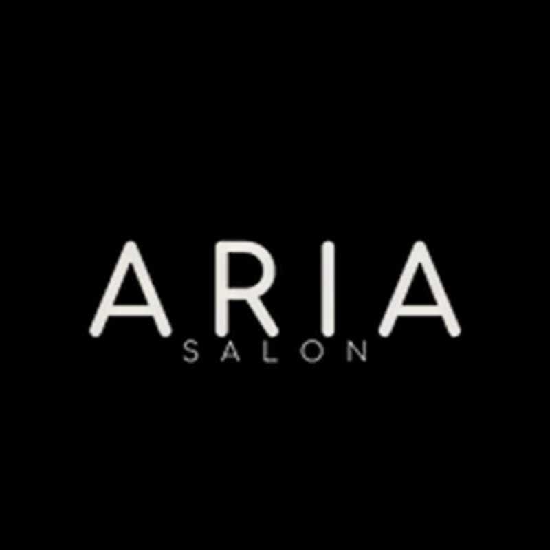 Portrait of Mechelle, a professional stylist at ARIA Salon, showcasing their expertise and style.
