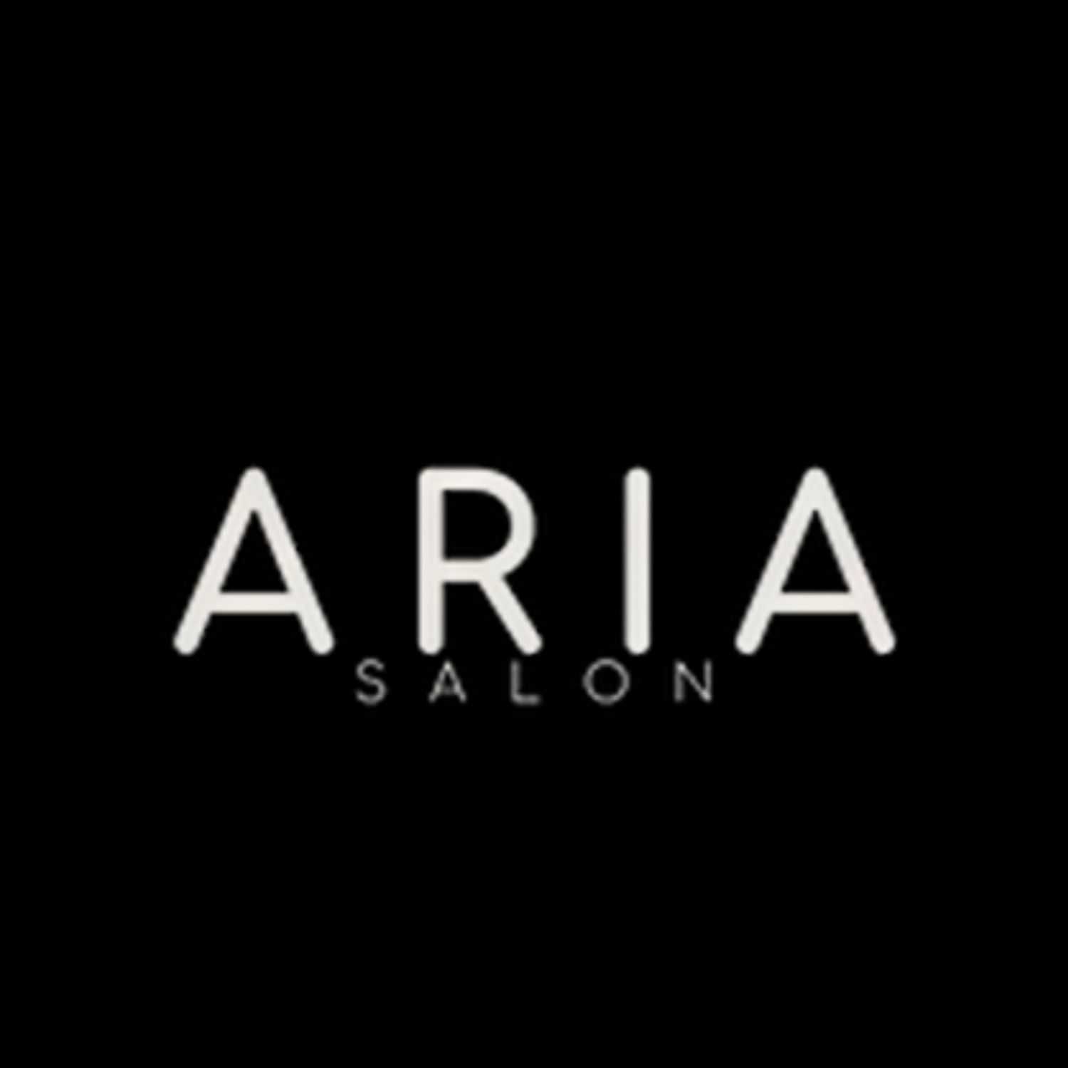 Portrait of Mechelle, a professional stylist at ARIA Salon, showcasing their expertise and style.