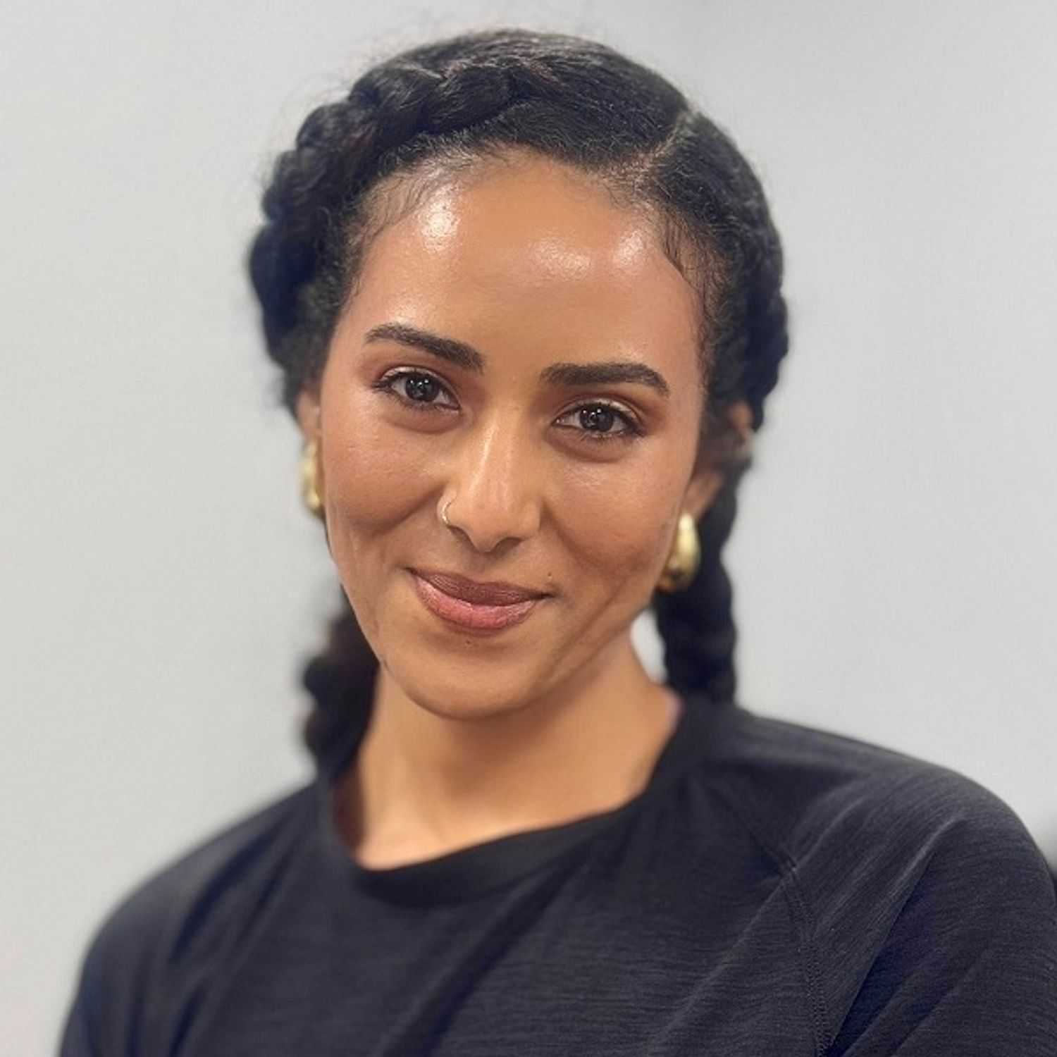 Portrait of Roshan, a professional stylist at ARIA Salon, showcasing their expertise and style.
