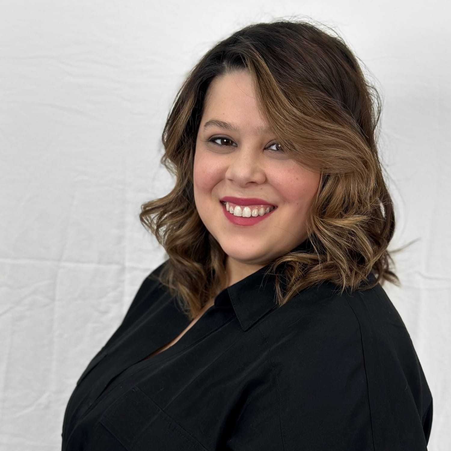 Portrait of Jessica, a professional stylist at ARIA Salon, showcasing their expertise and style.