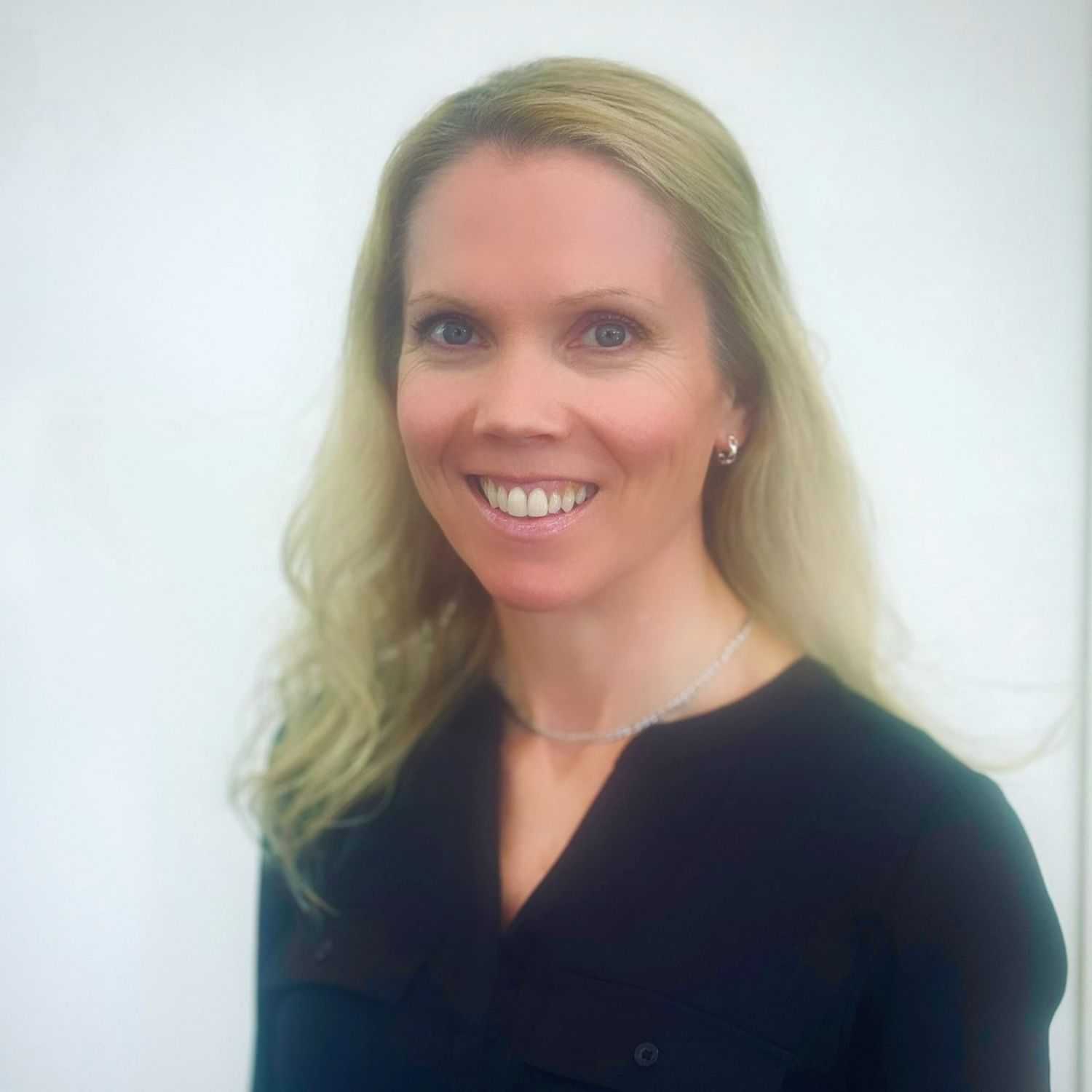 Portrait of Courtney, a professional stylist at ARIA Salon, showcasing their expertise and style.